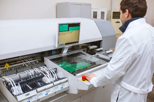 Pick-and-place stage of the SMT assembly process seating surface-mount components onto a printed circuit board